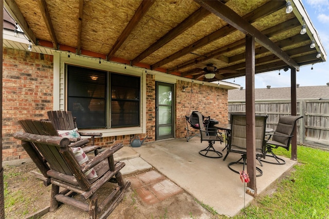 view of patio featuring fence and ceiling fan