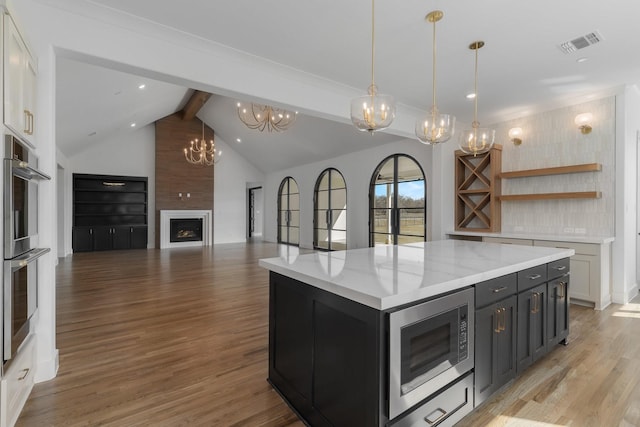 kitchen with visible vents, appliances with stainless steel finishes, light wood-style flooring, an inviting chandelier, and white cabinetry