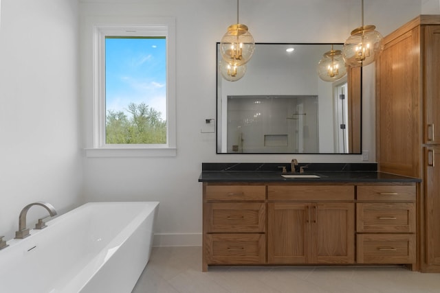 bathroom featuring a freestanding tub, tile patterned flooring, walk in shower, baseboards, and vanity