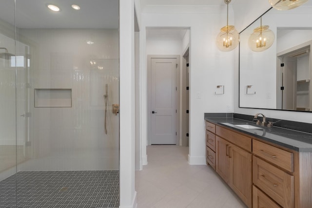 bathroom featuring recessed lighting, tiled shower, and vanity