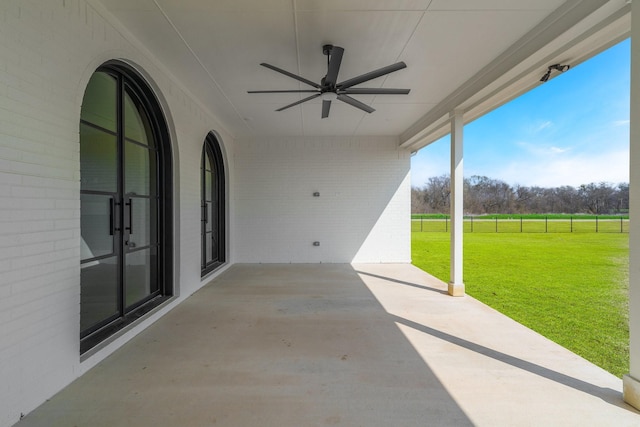 view of patio with fence and a ceiling fan