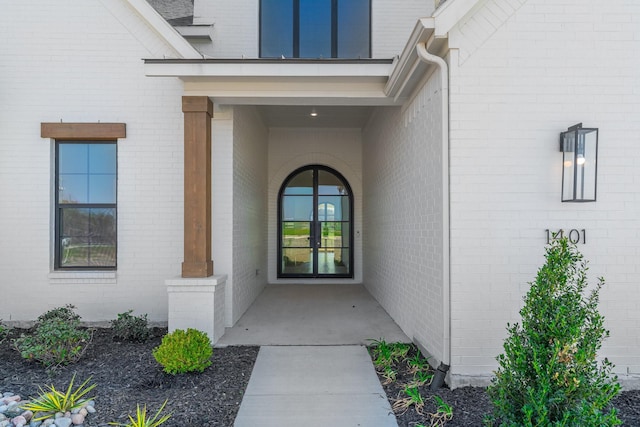 property entrance with brick siding