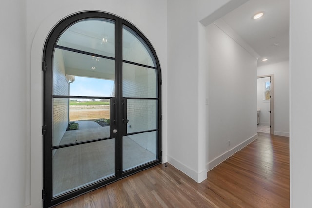 foyer entrance with baseboards, french doors, recessed lighting, and wood finished floors