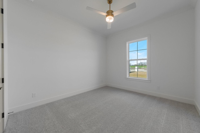 unfurnished room featuring a ceiling fan, baseboards, and light colored carpet