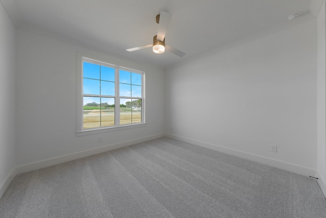 unfurnished room with baseboards, ceiling fan, and light carpet