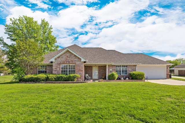 single story home with brick siding, a garage, driveway, and a front yard