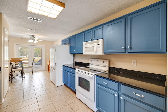 kitchen with dark countertops, blue cabinetry, white appliances, and visible vents