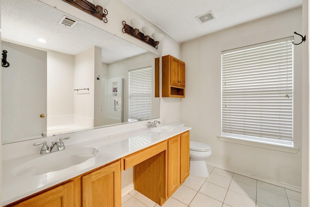 bathroom with a sink, toilet, double vanity, and visible vents