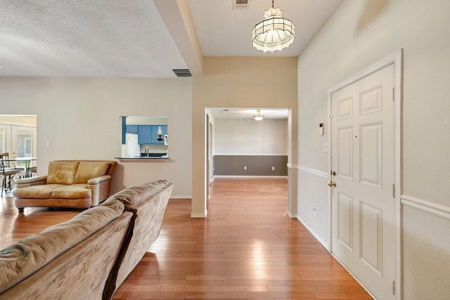 interior space with wood-type flooring, baseboards, and visible vents