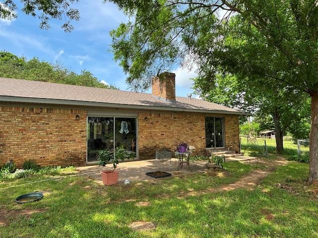 46916 US Highway 69 N, Bullard, TX 75757 - back of house with a lawn, brick siding, a chimney, and a patio