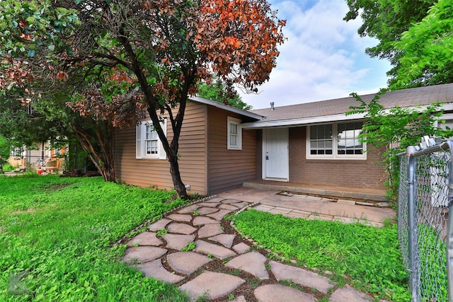 890 Sammons St, Abilene, TX 79605 - rear view of property with a lawn, brick siding, fence, and roof with shingles