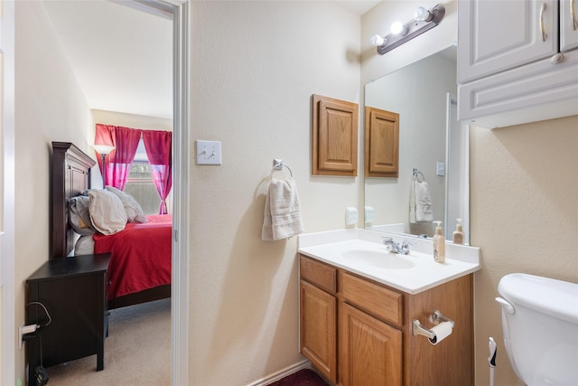 ensuite bathroom featuring toilet, ensuite bath, and vanity