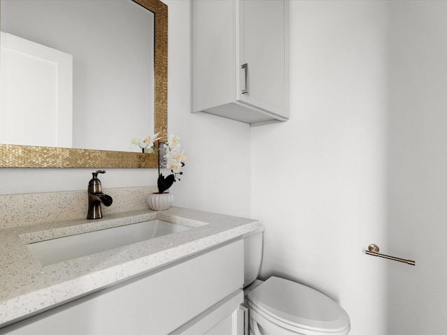 bathroom featuring toilet and vanity
