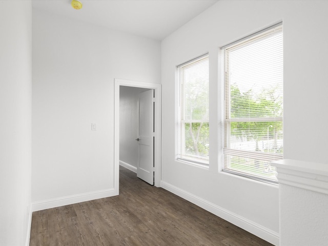 empty room featuring baseboards and wood finished floors
