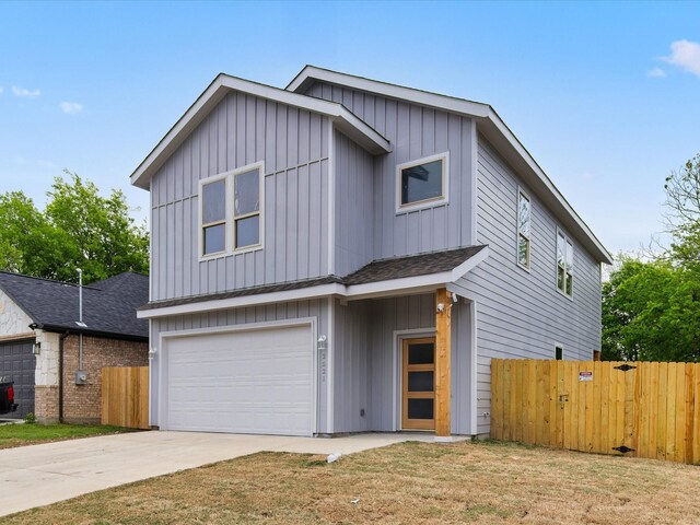 view of front of home with a garage, board and batten siding, fence, and concrete driveway