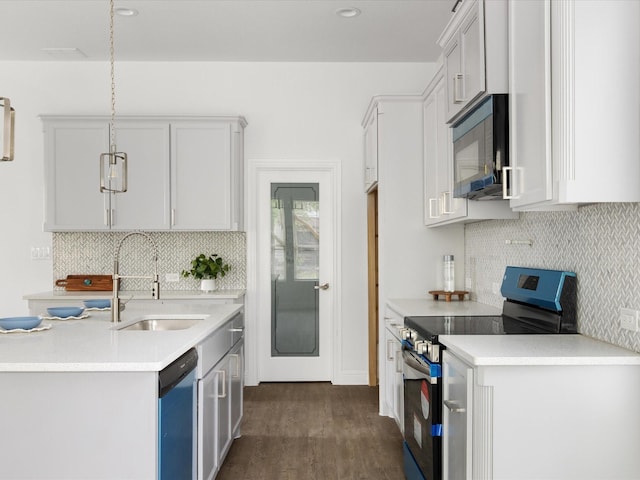 kitchen featuring light countertops, electric range, black microwave, and a sink