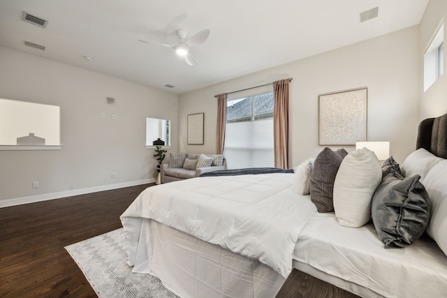 bedroom featuring baseboards, dark wood-style floors, multiple windows, and visible vents