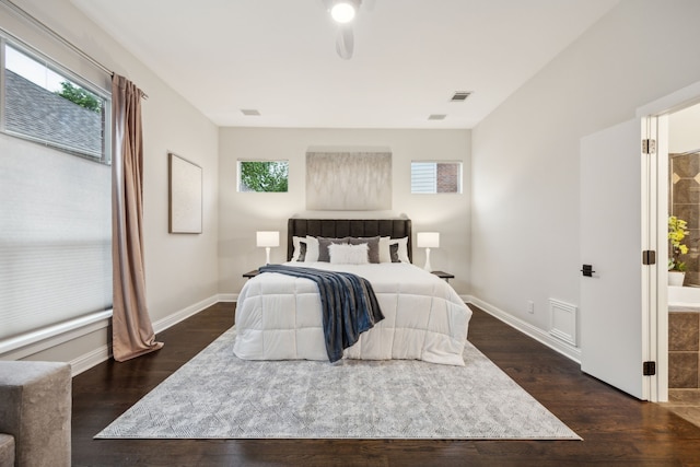 bedroom with baseboards, dark wood-style flooring, and visible vents