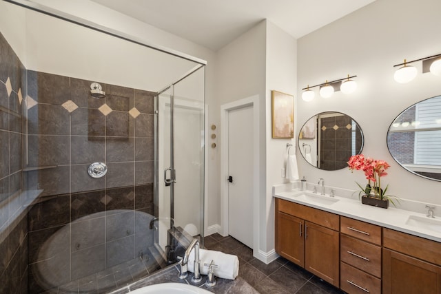 bathroom featuring double vanity, a sink, tile patterned flooring, and a shower stall
