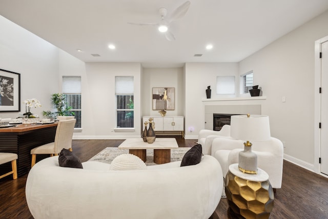 living room featuring recessed lighting, a ceiling fan, dark wood-style flooring, and baseboards