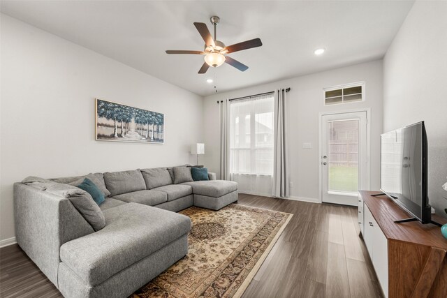 living area with baseboards, a ceiling fan, dark wood-style flooring, and recessed lighting
