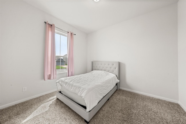 carpeted bedroom featuring baseboards