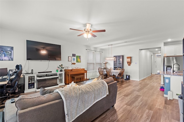 517 Williams Way, Van Alstyne, TX 75495 - living area with a ceiling fan, baseboards, recessed lighting, and light wood-style floors