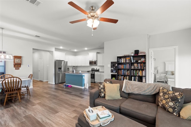 517 Williams Way, Van Alstyne, TX 75495 - living room featuring ceiling fan, recessed lighting, wood finished floors, and visible vents
