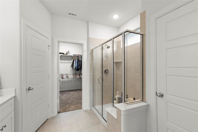 517 Williams Way, Van Alstyne, TX 75495 - full bathroom featuring a walk in closet, visible vents, tile patterned flooring, a stall shower, and vanity