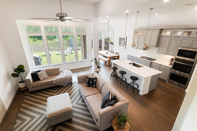 living room featuring recessed lighting, ceiling fan, dark wood-style floors, and visible vents