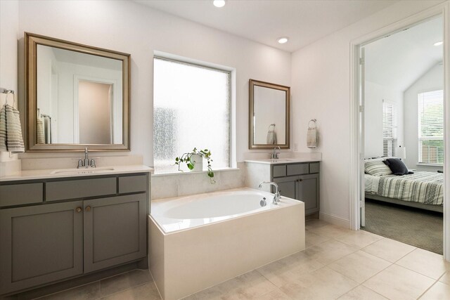 bathroom with connected bathroom, tile patterned floors, a sink, and a bath