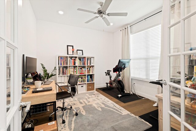 office with baseboards, ceiling fan, and wood finished floors