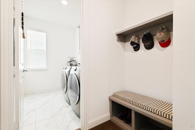 laundry area featuring washing machine and clothes dryer, laundry area, baseboards, and marble finish floor