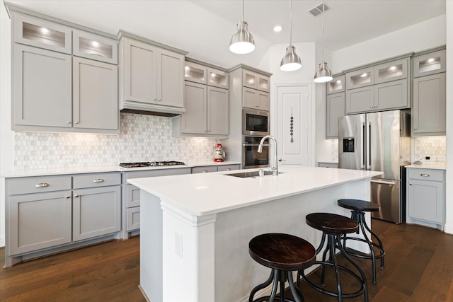 kitchen featuring gray cabinetry, appliances with stainless steel finishes, a sink, and visible vents