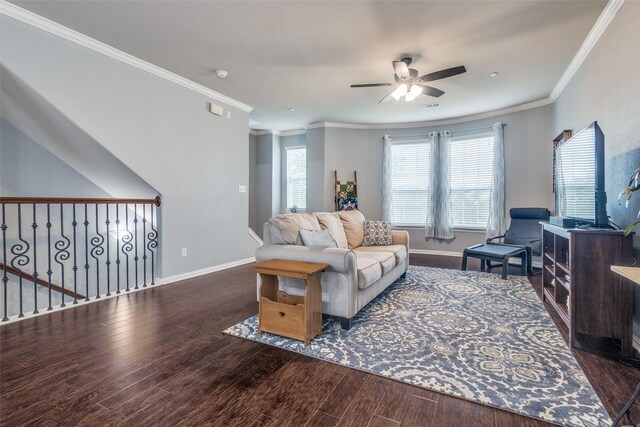 living area with ceiling fan, visible vents, wood finished floors, baseboards, and ornamental molding