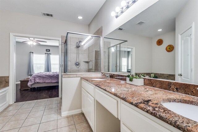 ensuite bathroom with visible vents, a sink, and a shower stall