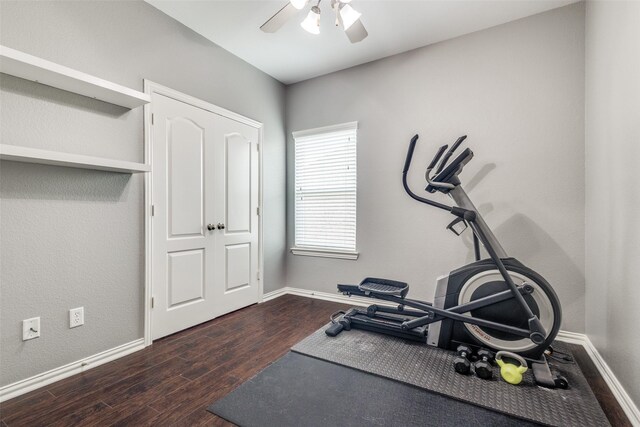 workout room featuring baseboards, a ceiling fan, and wood finished floors