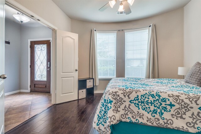 bedroom with baseboards and multiple windows