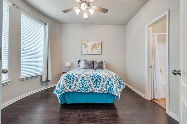bedroom featuring a ceiling fan, baseboards, multiple windows, and wood finished floors