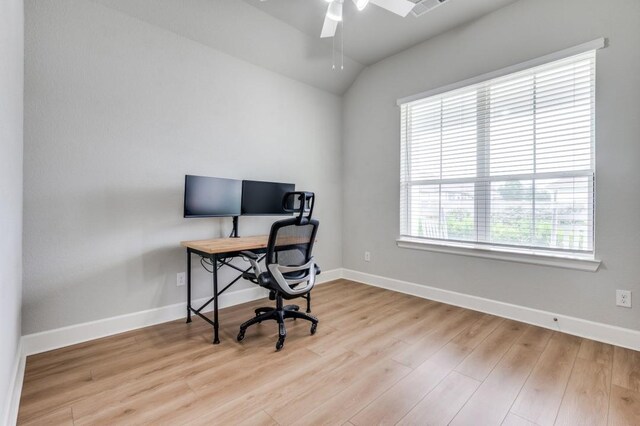 office space featuring baseboards, ceiling fan, vaulted ceiling, and wood finished floors