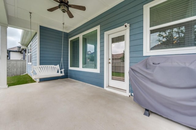 view of patio featuring a ceiling fan, fence, and a grill