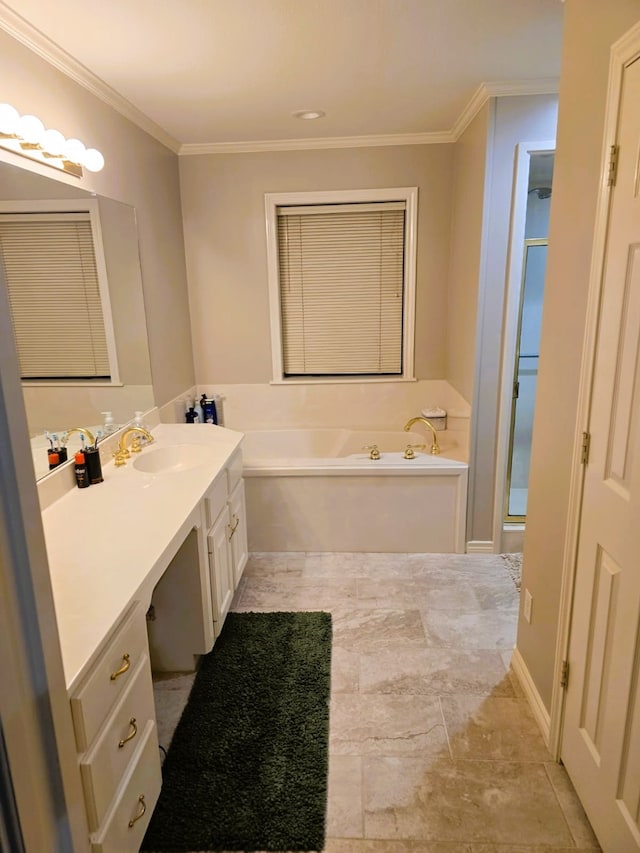 full bathroom with vanity, crown molding, and a bath