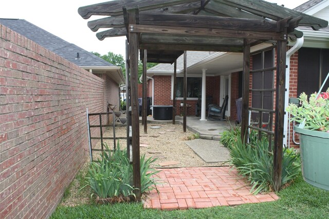 view of patio / terrace with a pergola, central AC, and fence