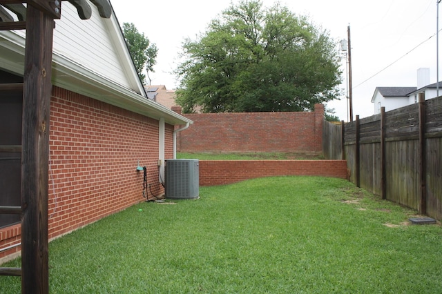 view of yard with fence and cooling unit