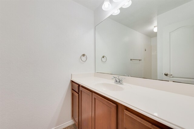 bathroom with baseboards and vanity