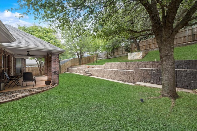 view of yard with a patio, a ceiling fan, and a fenced backyard