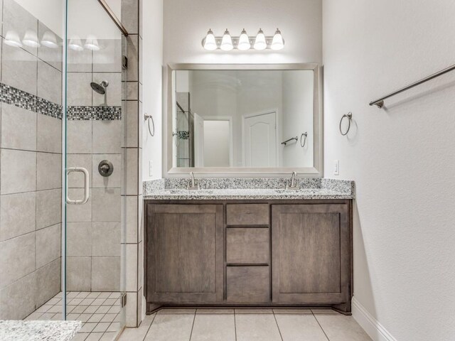 2012 Ranchwood Dr, Wylie, TX 75098 - bathroom with a stall shower, double vanity, and tile patterned floors