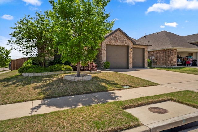 view of front of house featuring an attached garage, driveway, a front lawn, and brick siding