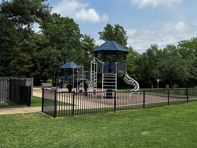 community jungle gym featuring fence and a yard