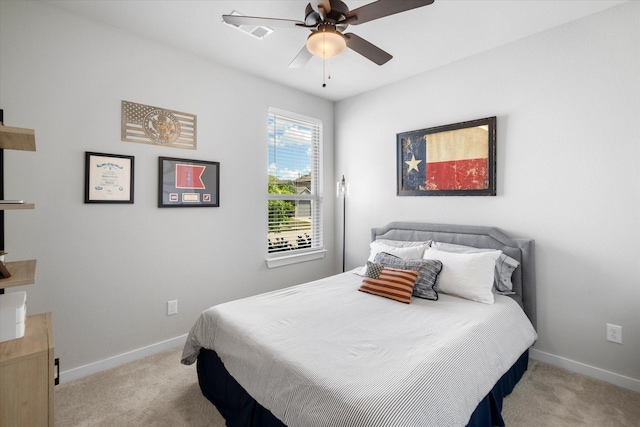 bedroom featuring baseboards, visible vents, and light carpet